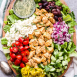 This Chicken Souvlaki Salad is loaded with all of your favorite Greek toppings! A quick and easy marinade makes the chicken extra flavorful and juicy. You'll love this healthy main dish salad! #chickensouvlaki #chicken #salad #healthysalad #dinner #glutenfree #lowcarb