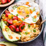 This Savory Southwest Oatmeal is a great way to change up your usual sweet oatmeal routine. Oatmeal seasoned with chili powder and cumin then topped off with avocado slices, cheese, tomatoes and an egg. Perfect for a hearty breakfast or even dinner! #oatmeal #savoryoatmeal #southwestrecipe #breakfast #glutenfree #egg #avocado
