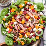 Steak Salad with Sweet Potatoes, Feta and Cranberries is a delicious and filling main dish salad. You'll love the savory, sweet and salty toppings and there's plenty of protein to help keep you full and satisfied! #salad #steak #steaksalad #glutenfree #healthyrecipe #dinner #sweetpotato