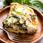 Crustless Sausage, Kale and Ricotta Quiche on wooden plate
