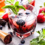 Mixed Berry Mint Julep with muddler, mint and berries