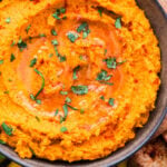 Paleo Roasted Carrot and Sweet Potato Hummus topped with cilantro