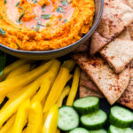 Paleo Roasted Carrot and Sweet Potato Hummus on platter with veggies and pita
