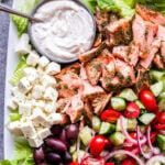 Greek Salmon Salad with Tahini Yogurt Dressing on white platter