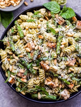 Grilled Chicken and Asparagus Pesto Pasta garnished with basil and pine nuts.