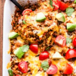 Black spoon scooping out Southwest Lentil and Brown Rice Casserole.