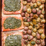 Sheet Pan Pesto Salmon and Potatoes side by side on a sheet pan.