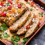 Mediterranean Turkey Meatloaf on a sheet pan topped with roasted red pepper, feta and parsley