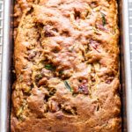 Overhead photo of vegan zucchini bread in a metal loaf pan.