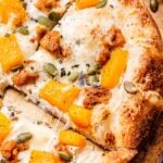 A corner slice of the Butternut Squash Sausage and Ricotta Pizza.