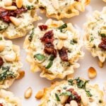 Sun Dried Tomato Pesto Goat Cheese Bites on a white plate.