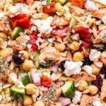 closeup photo of Mediterranean Salmon Orzo Salad with feta, chickpeas, roasted red peppers and cucumbers.
