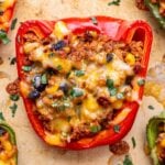 Closeup of a ground turkey taco stuffed red bell pepper.