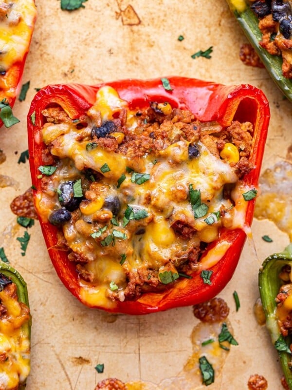 Closeup of a ground turkey taco stuffed red bell pepper.