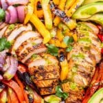 grilled sliced red and yellow peppers, red onion and sliced grilled chicken on top of romaine lettuce.