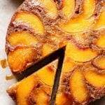 Round Cinnamon Peach Yogurt Cake with a slice cut out.