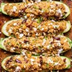 six Mediterranean Zucchini Boats on a sheet pan.