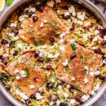 Greek Salmon and Orzo in a stainless steel skillet