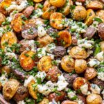herb roasted potatoes with blue cheese in a serving bowl.