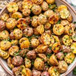 white serving bowl full of Everything Bagel Roasted Potatoes.