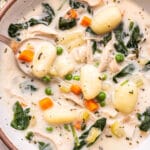 overhead photo of Chicken Gnocchi Soup in a bowl with a spoon.