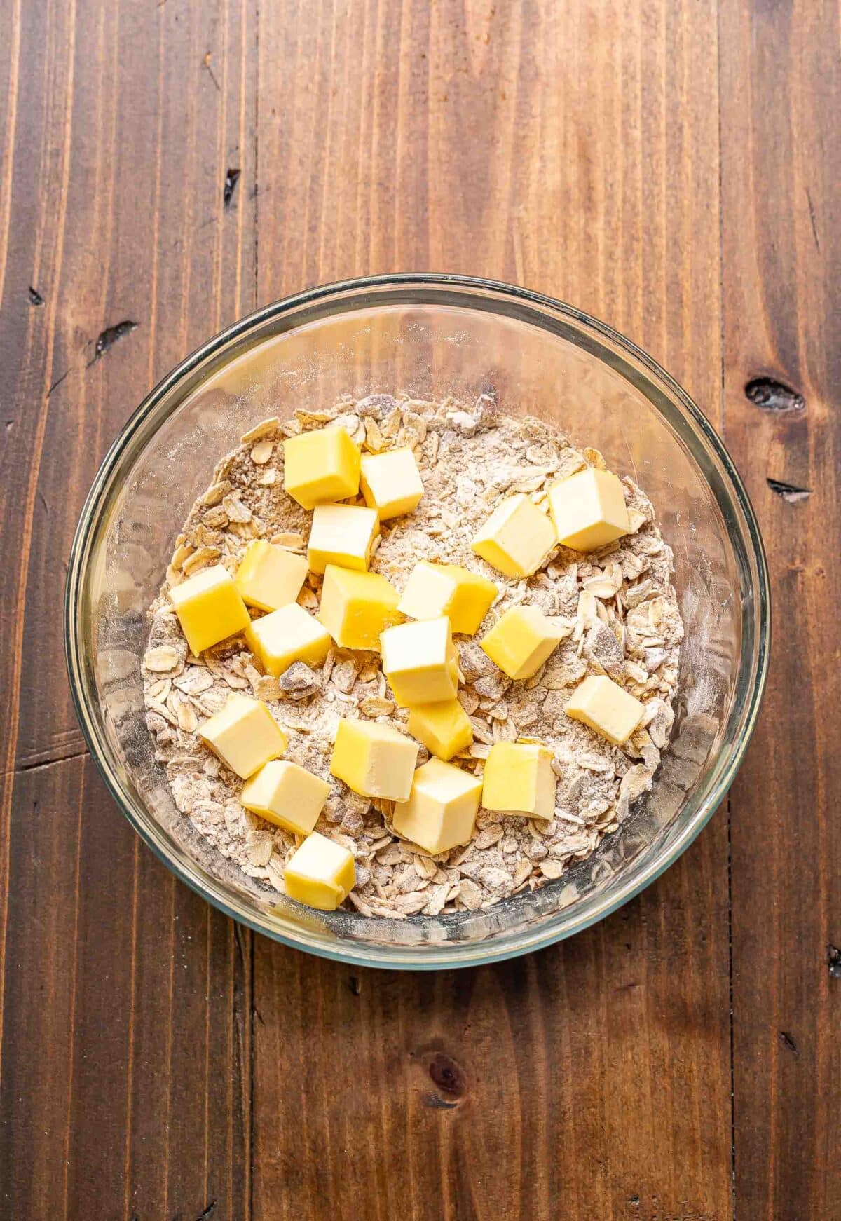Crisp topping with cubes of butter in a glass bowl.