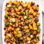 Roasted Butternut Squash and Brussels Sprouts Salad on a white plate.