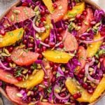 overhead photo of Citrus Cabbage Salad topped with slices of orange and grapefruit.