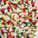 Strawberry Avocado Spinach Salad on a white oval serving platter.