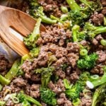 wooden spoon scooping up Teriyaki Ground Beef and Broccoli out of a skillet.