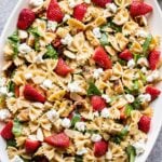 Strawberry Chicken and Spinach Pasta Salad on an oval white serving platter.