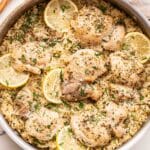 Lemon Chicken and Rice in a skillet with a wooden spoon behind the skillet.