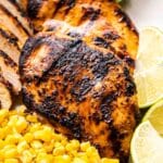 Margarita Grilled Chicken breasts with corn in front of them.