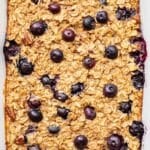 Blueberry banana bread baked oatmeal in a white rectangular baking dish.