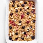 Baked apple berry baked oatmeal in a rectangular white baking dish.