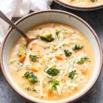 Broccoli Cheese Soup in a bowl with a spoon.