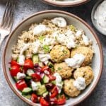 Greek Chicken Meatball Bowl with Greek salad and tzatziki dressing.