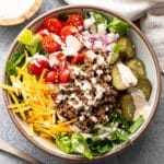 Cheeseburger salad in a white bowl.