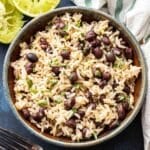 Black Beans and Rice in a bowl with a halved lime behind the bowl.