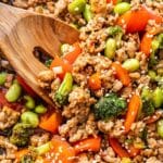 Wooden spoon in ground turkey stir fry.