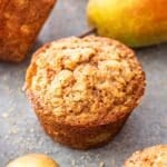 Pear ginger muffin with a pear in the background