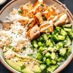 Bang bang salmon rice bowl with cucumber edamame salsa.
