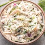Tzatziki shredded chicken salad in a white bowl.