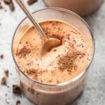 Cottage Cheese Chocolate Mousse in a glass with a spoon in the glass.