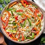 Sesame chicken noodle salad in a white serving bowl.