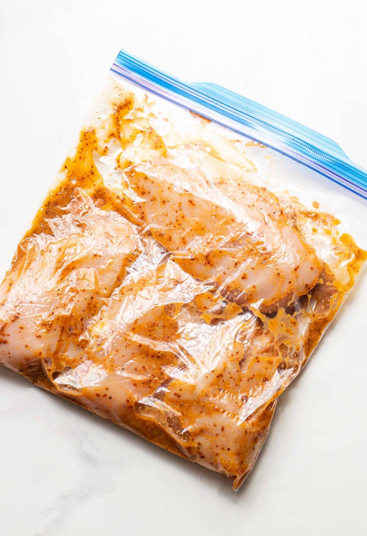 Honey mustard chicken marinating in a freezer bag.