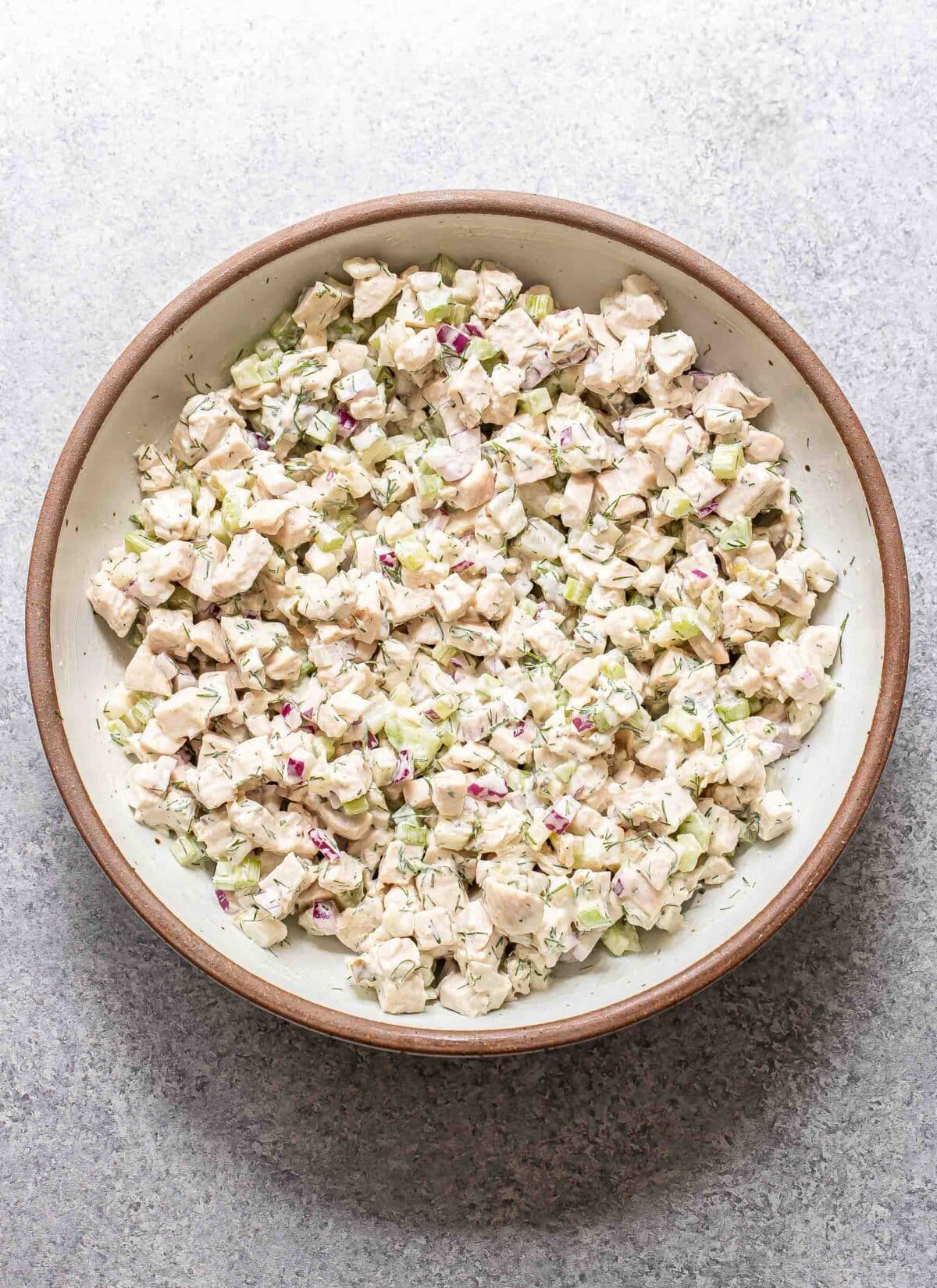 Dill pickle chicken salad in a white bowl.