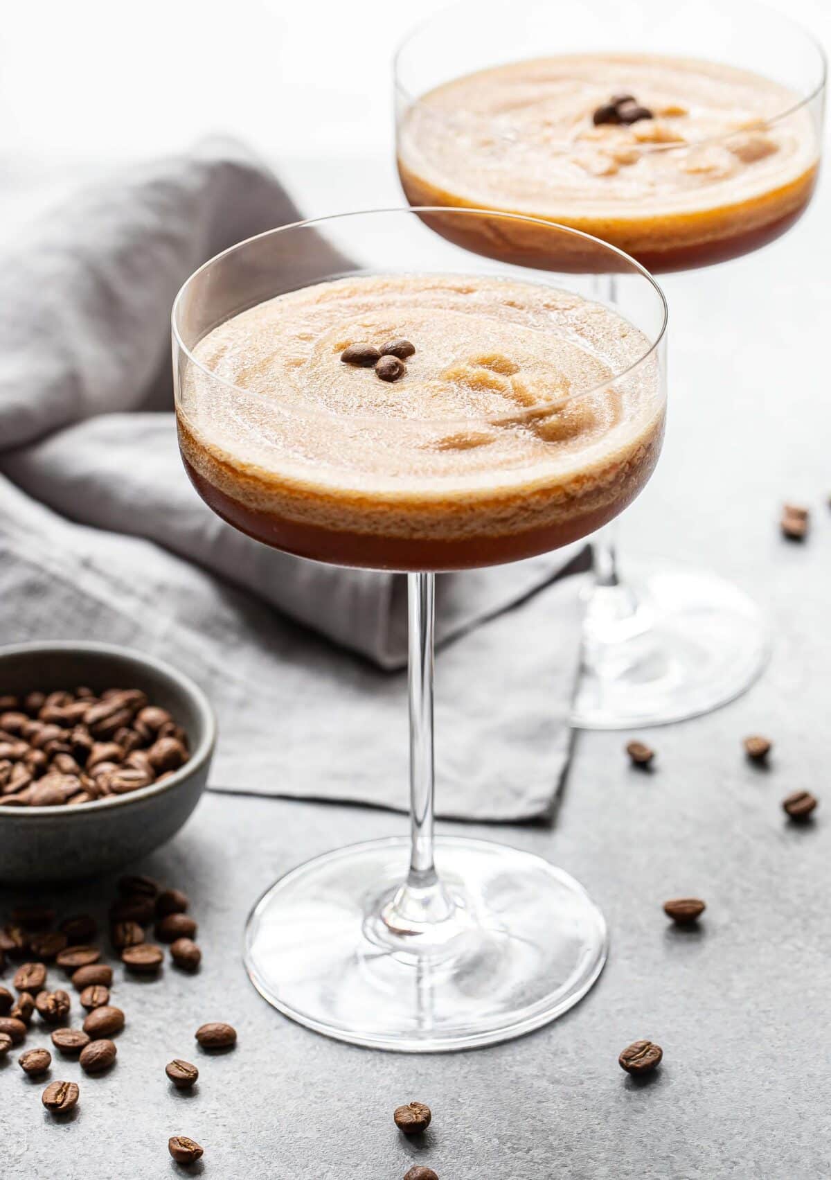 Two frozen espresso martinis in stemmed glasses.