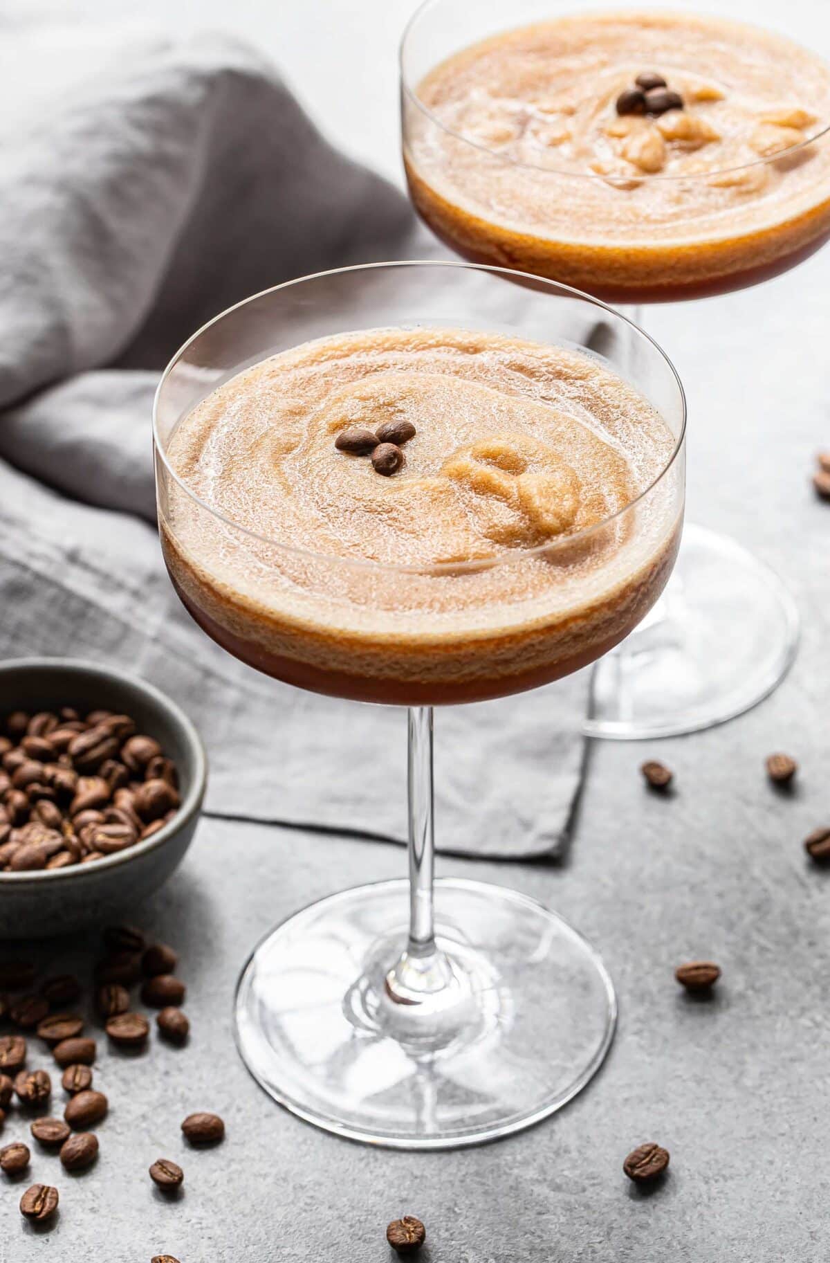 Two frozen espresso martinis in stemmed glasses.