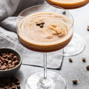 Two frozen espresso martinis in stemmed glasses.